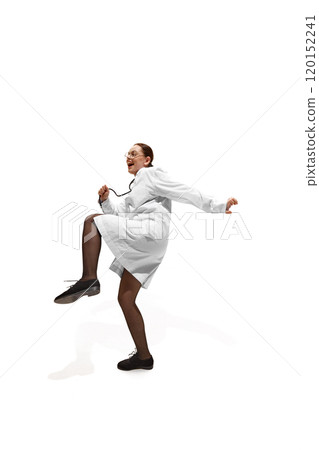 Dynamic photo of young woman, doctor in full gear, with stethoscope, dancing because she cured patient against white studio background. 120152241