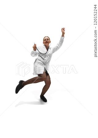 Young woman, dressed as doc, dancing rising hands and legs, showing willingness to help people against white studio background. 120152244