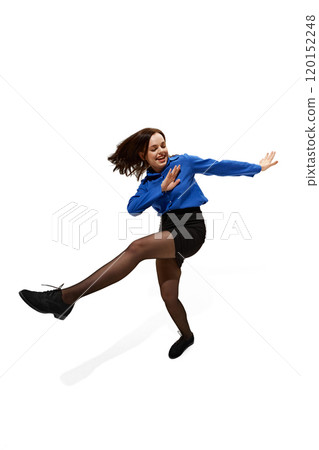 Happy young woman dancing of joy and happiness against white studio background. Female model dressed formal attire. Happy young woman dancing of joy and happiness against white studio background. Female model dressed formal attire. 120152248