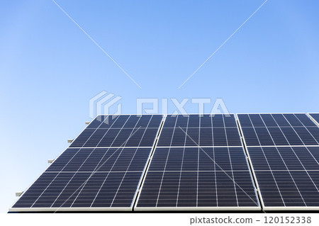 Aerial view of solar panel cells on clear blue sky background. Clean alternative energy power concept, sustainable resources. Modern house, solar panels stand-alone photovoltaic plant system on roof Aerial view of solar panel cells on clear blue sky background. Clean alternative energy power concept, sustainable resources. Modern house, solar panels stand-alone photovoltaic plant system on roof 120152338