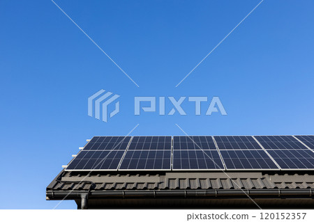 House with solar panels photovoltaic plant system professionally installed on metal sheet roof, go green. Clear blue sky background. Clean alternative energy power concept, sustainable resources 120152357