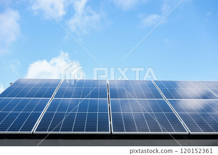Solar panel cells on cloudy blue sky background. Clean alternative energy power concept. Modern house with solar panels stand-alone photovoltaic plant system on metal sheet roof. Go green 120152361
