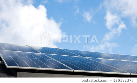 Aerial view of solar panel stand-alone photovoltaic plant system on cloudy blue sky background. Clean alternative energy power in nature concept, sustainable resources. Professional installation 120152373
