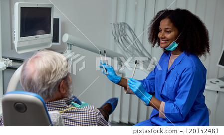 Dentist explains benefits of dental brush teeth, detailing how it can improve patient's smile and dental confidence. 120152481