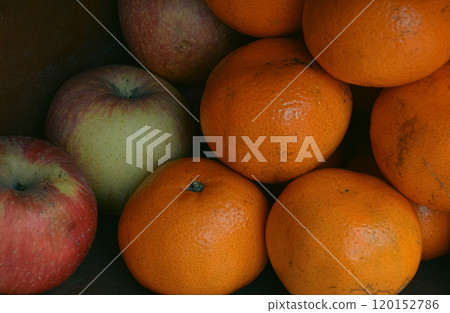 A collection of apples and oranges stacked together in a shelf, emphasizing natural colors and freshness A collection of apples and oranges stacked together in a shelf, emphasizing natural colors and freshness 120152786