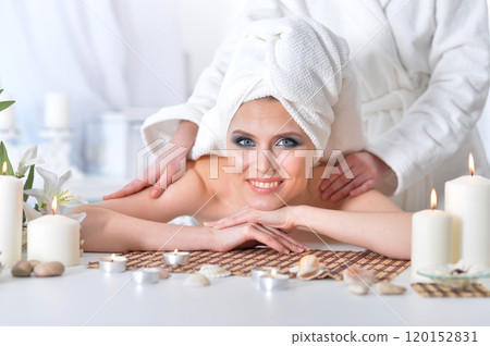 Beautiful woman in spa centar enjoying the massage. 120152831