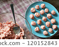 Making little meatballs at home 120152843