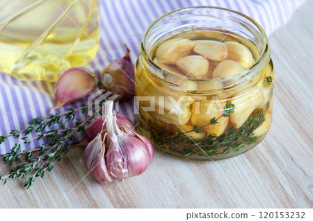 Garlic cloves pickled in sunflower oil and thyme. Garlic cloves pickled in sunflower oil and thyme. 120153232