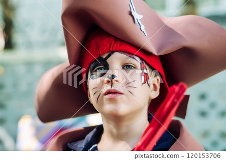 Boy Cat Pirate costume. Halloween party in kindergarten. Aqua makeup painted kids face. Bright festive Boy Cat Pirate costume. Halloween party in kindergarten. Aqua makeup painted kids face. Bright festive 120153706