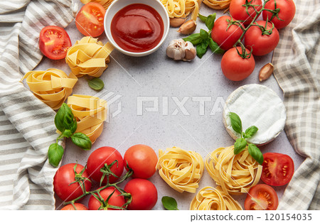 Frame of pasta ingredients forming a border on a gray background with copy space in the center Frame of pasta ingredients forming a border on a gray background with copy space in the center 120154035