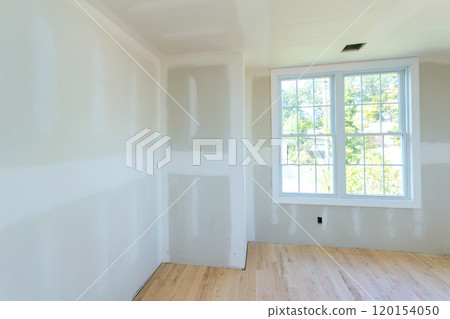 During construction, drywall is partially completed, but interior is unpainted drywall 120154050