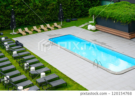 Luxury resort hotel garden with swimming pool and sun loungers, sun loungers by the pool Luxury resort hotel garden with swimming pool and sun loungers, sun loungers by the pool 120154768