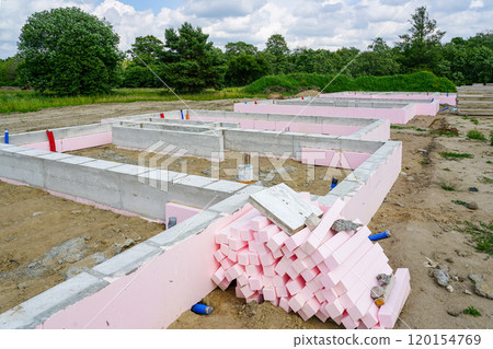 Thermal insulation with polystyrene plates around the perimeter of concrete foundations of a residential house 120154769