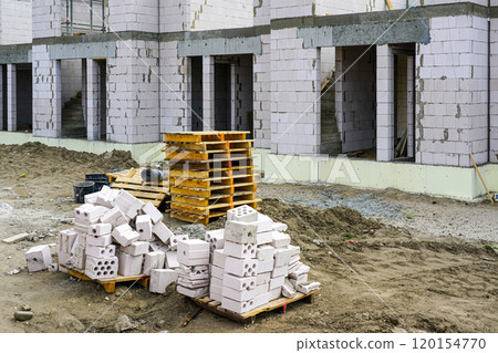 Construction site view of a new residential terraced house with thermally insulated foundations Construction site view of a new residential terraced house with thermally insulated foundations 120154770