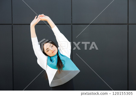 Cute sporty girl doing stretching on the street before training Cute sporty girl doing stretching on the street before training 120155305
