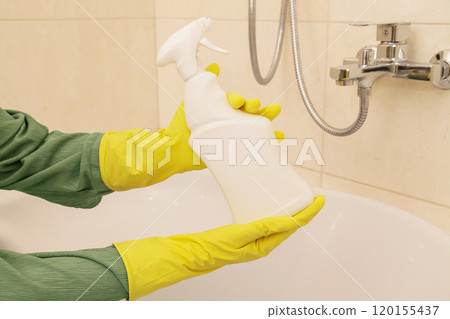 Household Chemicals Mockup. Hands Women Wearing Protect Glove Yellow using liquid Cleaning solution Cleaning Acrylic Bath, Disinfection and Hygiene Concept 120155437