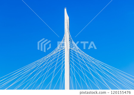 White metal cable-stayed bridge details are under blue sky 120155476