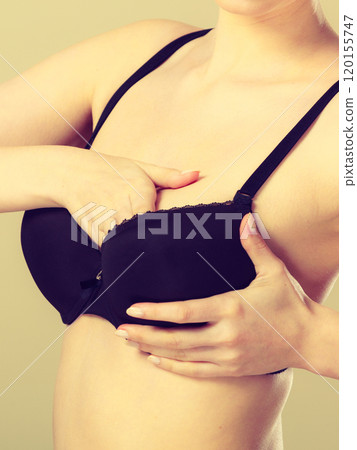 Girl getting comfortable in her bra 120155747