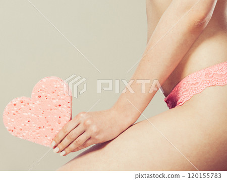 Woman holding heart shaped sponge in hand Woman holding heart shaped sponge in hand 120155783