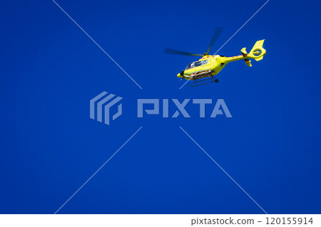 Yellow helicopter on clear dark blue sky Yellow helicopter on clear dark blue sky 120155914