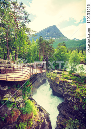 Tourist with camera on Gudbrandsjuvet waterfall, Norway 120155936