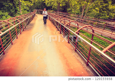 Tourist with camera on Gudbrandsjuvet viewpoint, Norway 120155938