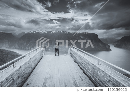 Tourist photographer with camera on Stegastein lookout, Norway Tourist photographer with camera on Stegastein lookout, Norway 120156023
