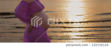 banner unrecognizable pregnant body of woman in profile in pink lightweight top and skirt against sunset sea 120156128