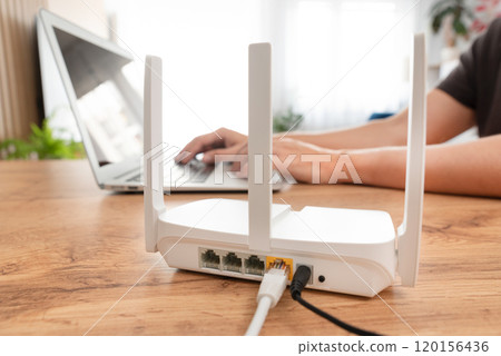 Modern wi-fi router on light table in room 120156436