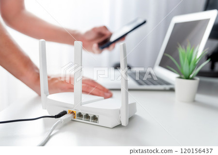 Modern wi-fi router on light table in room 120156437