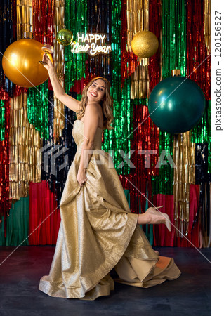 Party, luxury and people concept: Glamour women in luxury glitter golden dress drinking champagne Party, luxury and people concept: Glamour women in luxury glitter golden dress drinking champagne 120156527