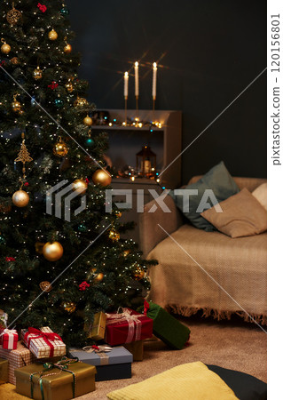 Vertical background image of dim home interior with decorated Christmas tree and gold details copy space 120156801