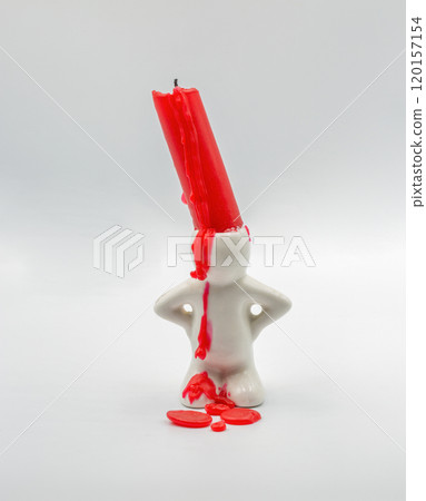Red candle stub in cute candlestick closeup on white Red candle stub in cute candlestick closeup on white 120157154