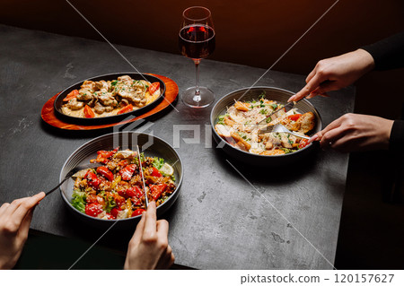 Elegant dining with gourmet dishes and a glass of wine, perfect for a cozy and sophisticated meal Elegant dining with gourmet dishes and a glass of wine, perfect for a cozy and sophisticated meal 120157627