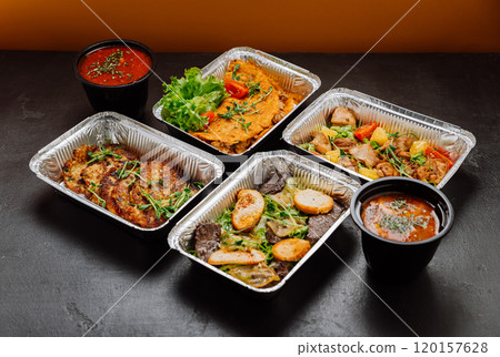 Delicious gourmet meal set in foil containers with salad and soup, ideal for catering or delivery Delicious gourmet meal set in foil containers with salad and soup, ideal for catering or delivery 120157628