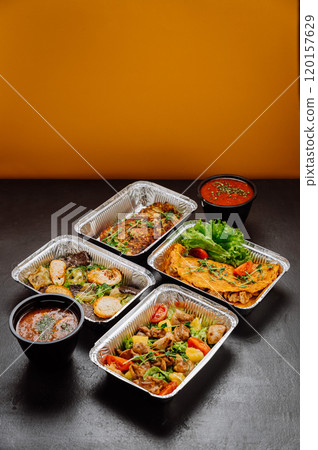 Delicious gourmet meal set in foil containers with salad and soup, ideal for catering or delivery Delicious gourmet meal set in foil containers with salad and soup, ideal for catering or delivery 120157629