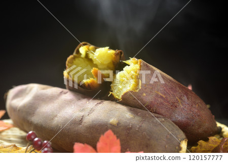 Steam rising from baked sweet potatoes and fallen leaves Steam rising from baked sweet potatoes and fallen leaves 120157777