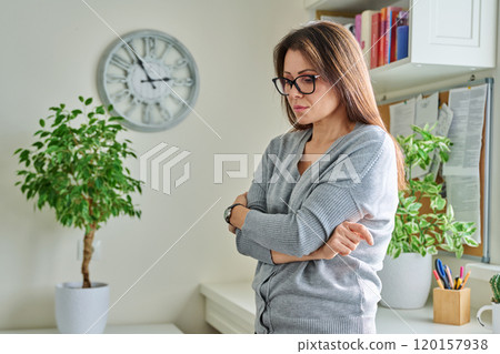 Middle aged unhappy thoughtful suffering lonely woman, at home Middle aged unhappy thoughtful suffering lonely woman, at home 120157938