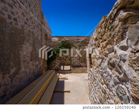 Ruined passageway made of stacked wooden boards (Spinalonga, Crete, Greece) 120159140
