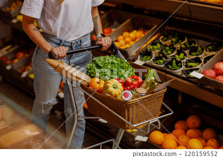 A Vibrant Array of Fresh Vegetables and Fruits Nicely Displayed in a Grocery Store Cart 120159552