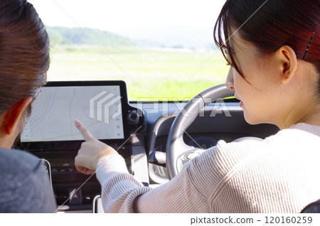 A young woman operating a car navigation system 120160259