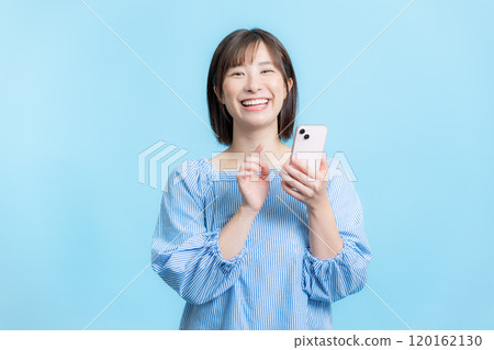 Woman operating a smartphone Woman operating a smartphone 120162130