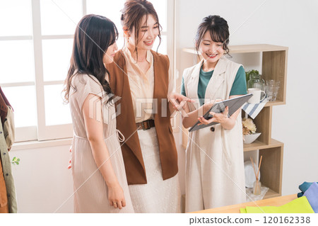 Women working in textile designers, fashion designers, pattern makers, stylists, and apparel. 120162338