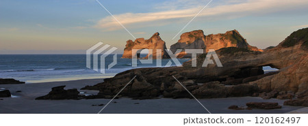 Arched rock formation at Wharariki Beach, New Zealand. Arched rock formation at Wharariki Beach, New Zealand. 120162497
