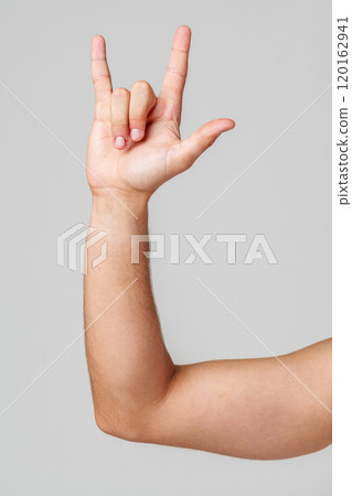 A person hand gesture against a neutral background A person hand gesture against a neutral background 120162941