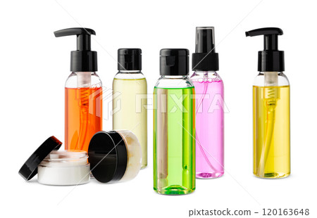 Variety of colorful personal care bottles and grooming accessories arranged on a white surface 120163648