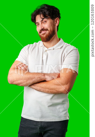 A young man with a beard showing a serious expression against a vibrant green background A young man with a beard showing a serious expression against a vibrant green background 120163809