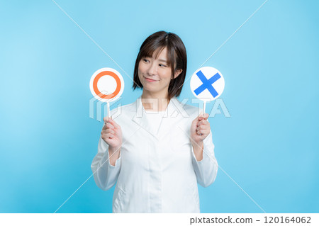A woman wearing a white lab coat and holding a round X plate A woman wearing a white lab coat and holding a round X plate 120164062