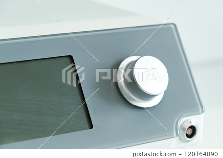 modern electronic control panel featuring a large rotary knob and digital display 120164090