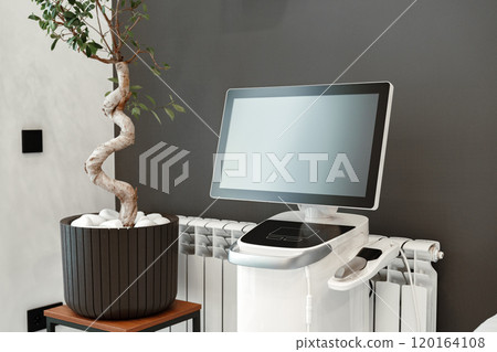 Modern medical equipment in a bright waiting area featuring a potted plant Modern medical equipment in a bright waiting area featuring a potted plant 120164108